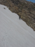 JJ kicking steps across a steep snow field on our way up to The Kettles.