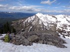 Reading the register notes, Sheep Creek Peak in the background.