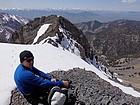 Taking a break above the crux, Lost River Range in the distance.