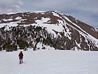 Alex crossing a snowfield below Flatiron Mountain.