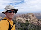 Me on the summit of Crest Peak, with Bridge Mountain and Las Vegas in the background.