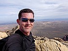 Me on the windy summit of Bridge Mountain, with Las Vegas in the background.