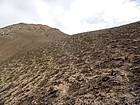 Hiking across fire scarred slopes.