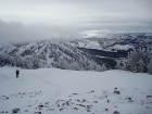 John leaving the summit, with Bull Trout Point off to the right, just behind the clouds.