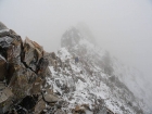 Getting pelted with wind and snow on the summit ridge.