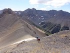 Climbing up from the saddle, massive north face of Mount Breitenbach in the background.