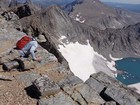 Peering over the cliff at the lake below.