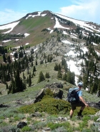 John leaving Pk 7859' with Council Mountain in the background.