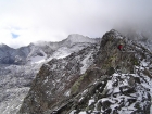 Sean on the ridge with the steep west face of the peak behind him.