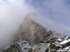 Looking up the ridge with the false summit peeking through the fog.