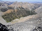 The verdant Dry Creek drainage. In the background are Triple Peak, Mount Corruption, The Cleft, & True Grit.