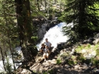 Posing next to a waterfall next to the trail.