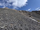 Heading up the scree on the southwest face of Gloved Peak.