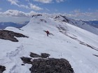 Traversing the ridge, Gloved Peak in the background.