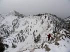 Erik leaving the named summit, heading toward the true highpoint.