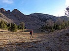 Passing the tarn at 9600' with Simpson Peak in the background.