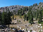 Starting to get above the trees, below Lone Elk Lake.