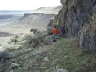 Hiking around the base of some short cliffs.