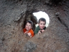 The boys peeking through a hole.