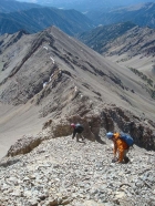 Down-climbing a loose section on the south ridge.