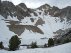A mostly frozen Pass Lake, with Peak 11967' above.