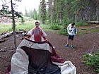 Setting up the tent during a break in the rain.