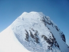 The scary summit block. Steep snow on a knife-edge ridge with cornices overhanging on both sides.