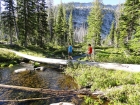 Crossing a log across the Marge Lake outlet stream.