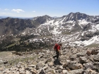 Steve climbing the east ridge, Pyramid Peak in the background.