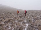 Getting blasted by wind and snow on our way down the upper peak.