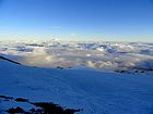 View from Camp Muir. Adams, Hood, and Saint Helens poking up through the clouds.