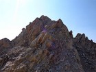 John trying to find a way up the Moolack Mountain summit block. He eventually found a slot going up from the notch on the left.