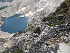 Dave scrambling on the south face of Daves Peak, Profile Lake far below. JohnF photo.