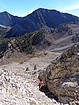 Tom scrambling up the couloir, Ivory Peak and Ebony Peak in the background.