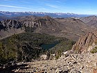 Six Lakes Basin below, Sawtooths in the distance, looking west from the ridge.