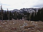 First view of Blue Lake, nestled down in the trees. Tripod Peak in the distance.