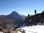 JJ and Dan Standing on Fourth of July Peak with Castle Peak in the background.