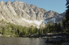 Ken fishing in Quiet Lake with Castle Peak towering above him.