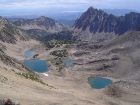 The view down on Four Lakes Basin from the summit of Patterson Peak with Merriam Peak in the background.