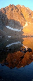 A fiery sunrise orange Castle Peak reflecting in Castle Lake.