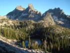 A view of the lowest Bead lake during my descent. Packrat, Mayan Temple, and La Fiamma form a dramatic backdrop.