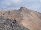 Scrambling the north ridge of Wet Peak with Hidden Peak in the background.