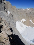 The steep north face of Mount Russell drops sharply to the frozen lake below.