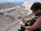 Signing the summit register on Mount Muir.